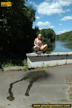 Outdoor pissing on embankment in summer day - N